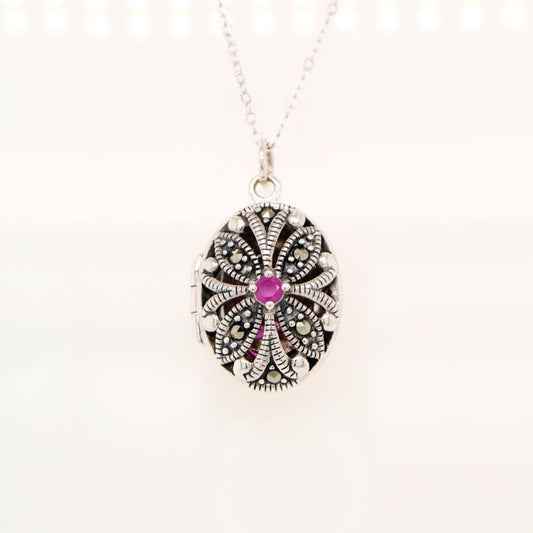 Flower locket in sterling silver with ruby and marcasite