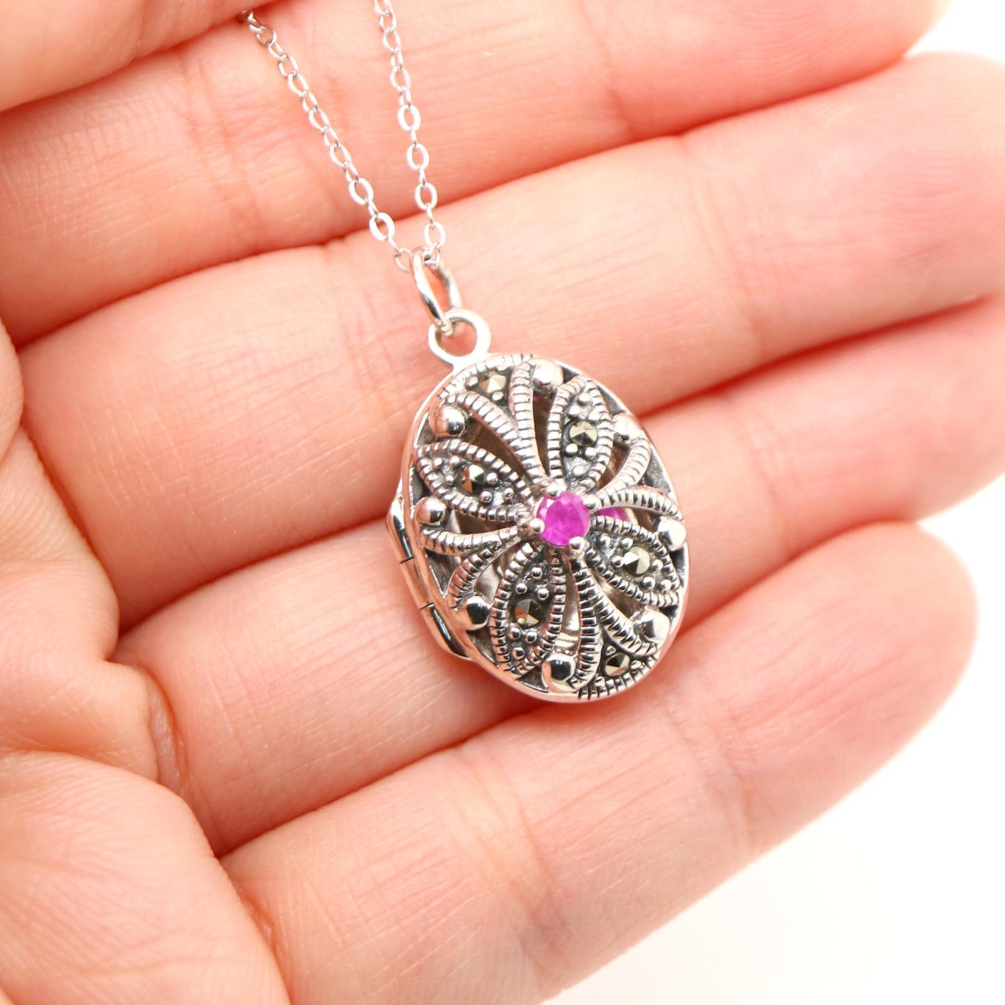 Flower locket in sterling silver with ruby and marcasite