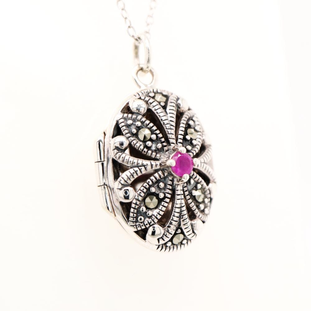 Flower locket in sterling silver with ruby and marcasite