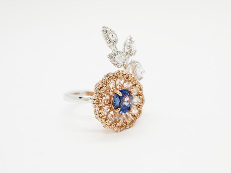 Diamond and sapphire flower ring with diamond leaf and blue sapphire solitaire centre, Rose gold flower ring with rose cut diamonds